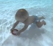 Little Olly Wilkes has learnt to swim before he could walk